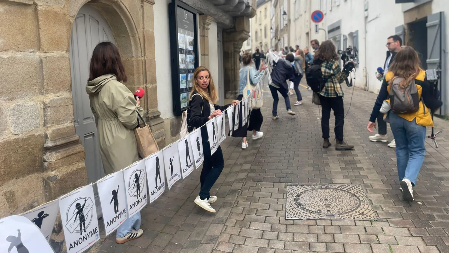 A long banner representing the many victims of Le Scouarnec was unfurled near the courthouse on Wednesday