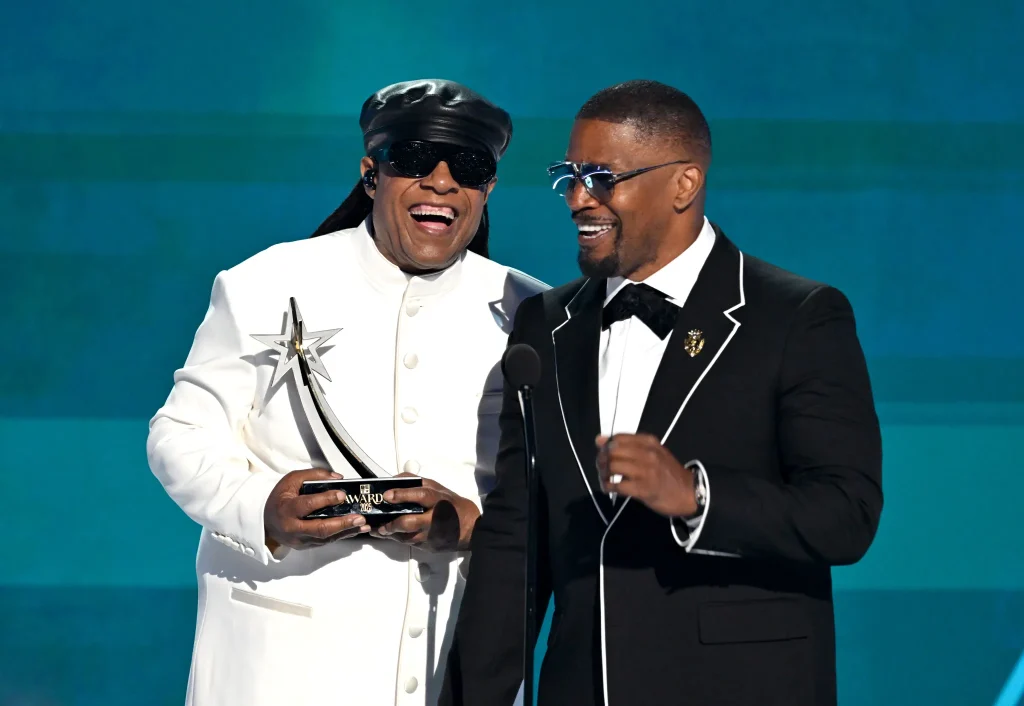 Legendary musician Stevie Wonder honors Jamie Foxx with the Ultimate Icon Award at the 2025 BET Awards, held at Peacock Theater in Los Angeles on June 9, 2025. (Photo by Paras Griffin/Getty Images for BET)